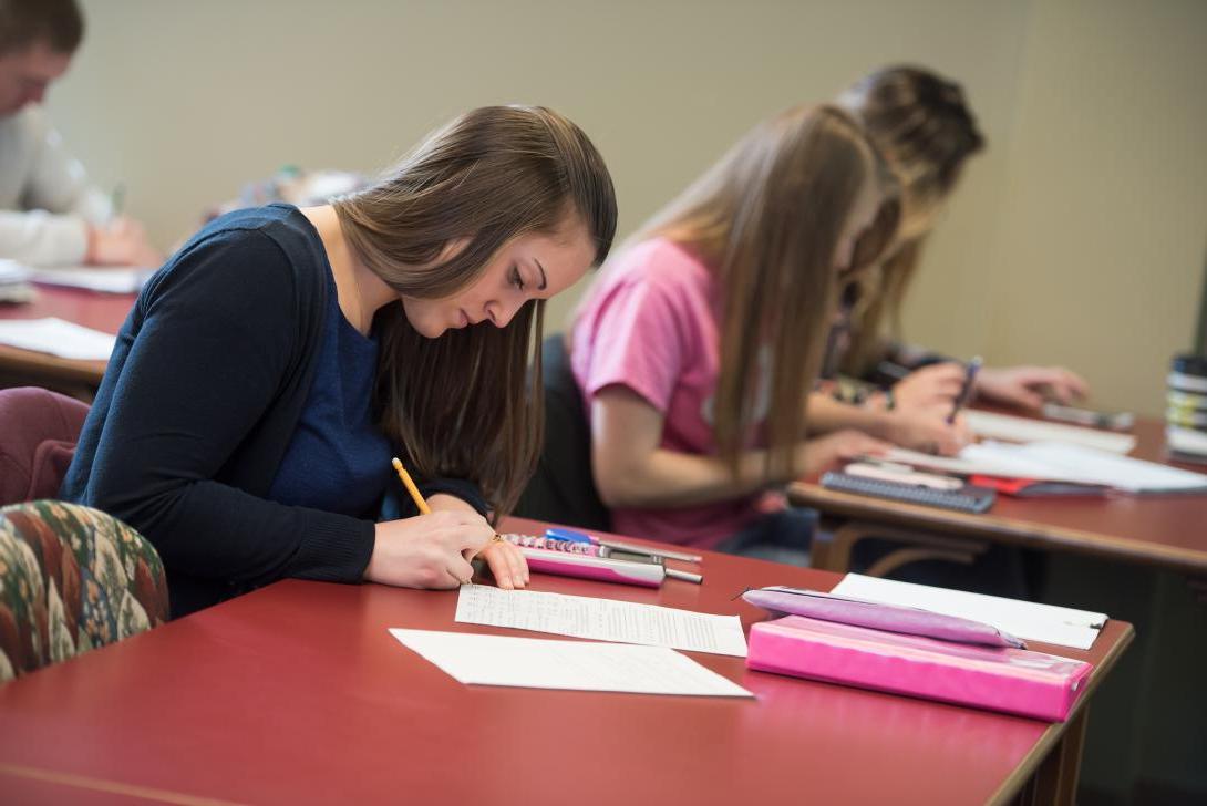 Students in classroom working on paperwork